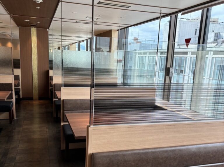 a room with a glass wall and a bench